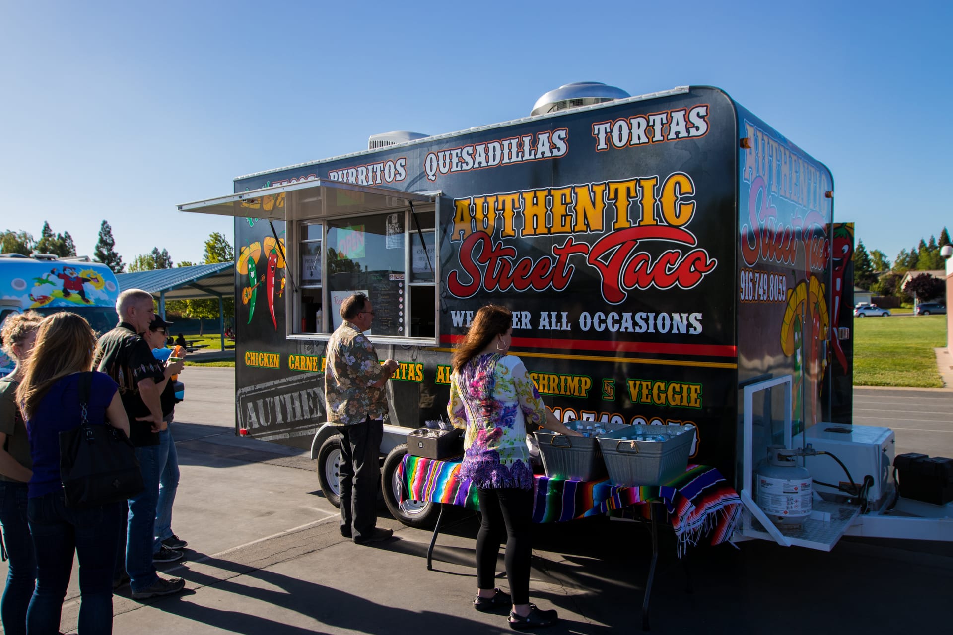 Guests queuing at the Authentic Street Taco food truck at an event