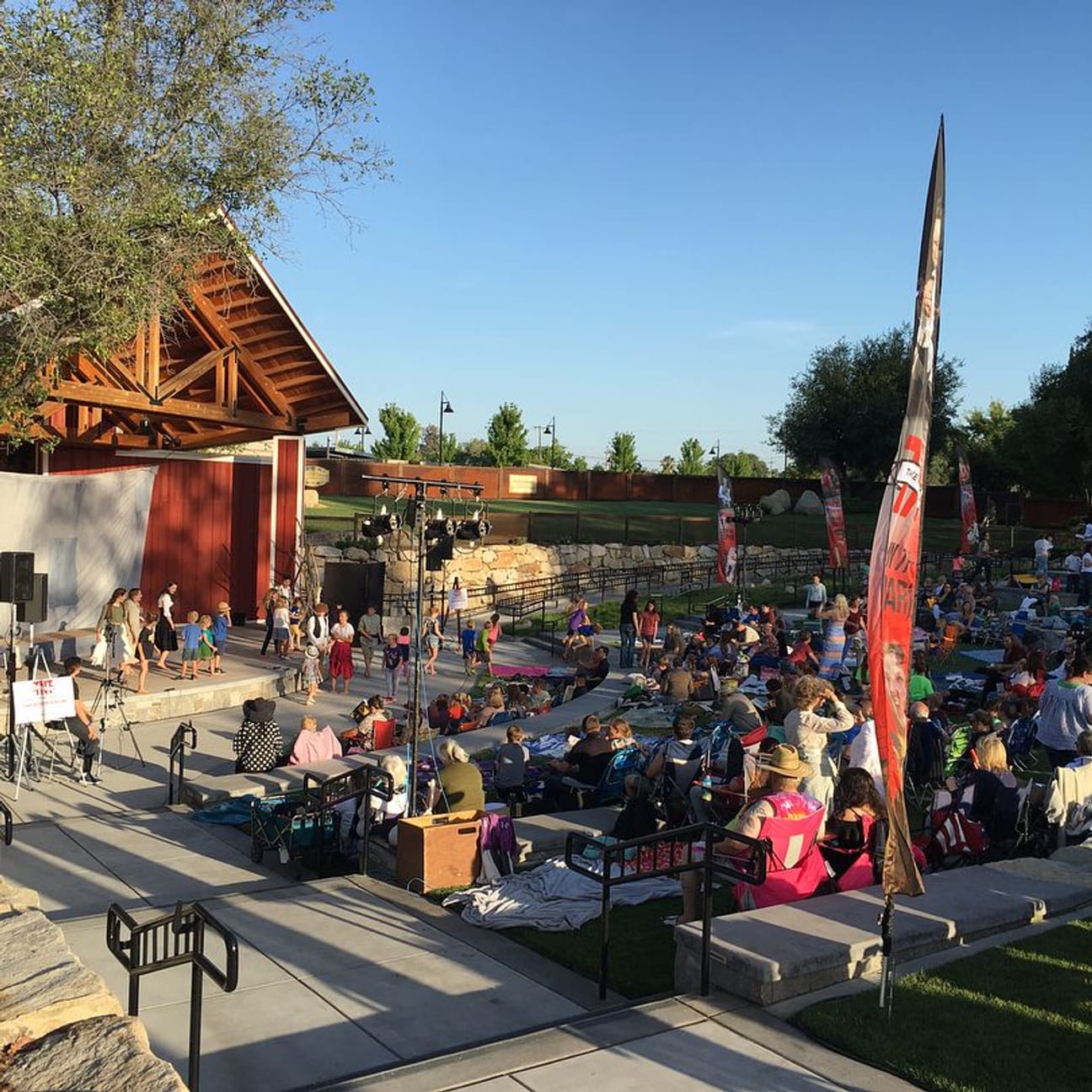 An outdoor campus event catered by Authentic Street Taco, with the crowd seated on the lawn